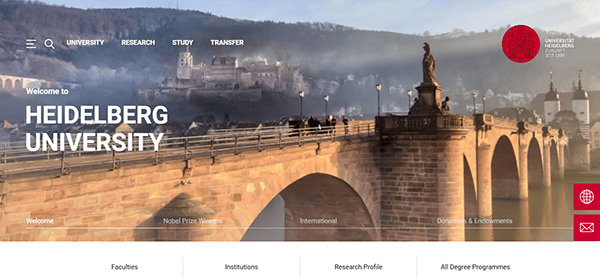 Old stone bridge with statues in Heidelberg, Germany, offering a picturesque view of the hills and castle. A warm welcome message for Heidelberg University graces the scene, echoing its status alongside top education sites worldwide.