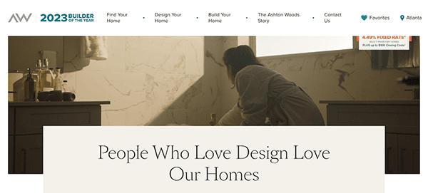 A person in a dimly lit bathroom, possibly conducting a home design activity. The website header has links for home design services and the text reads "People Who Love Design Love Our Homes.