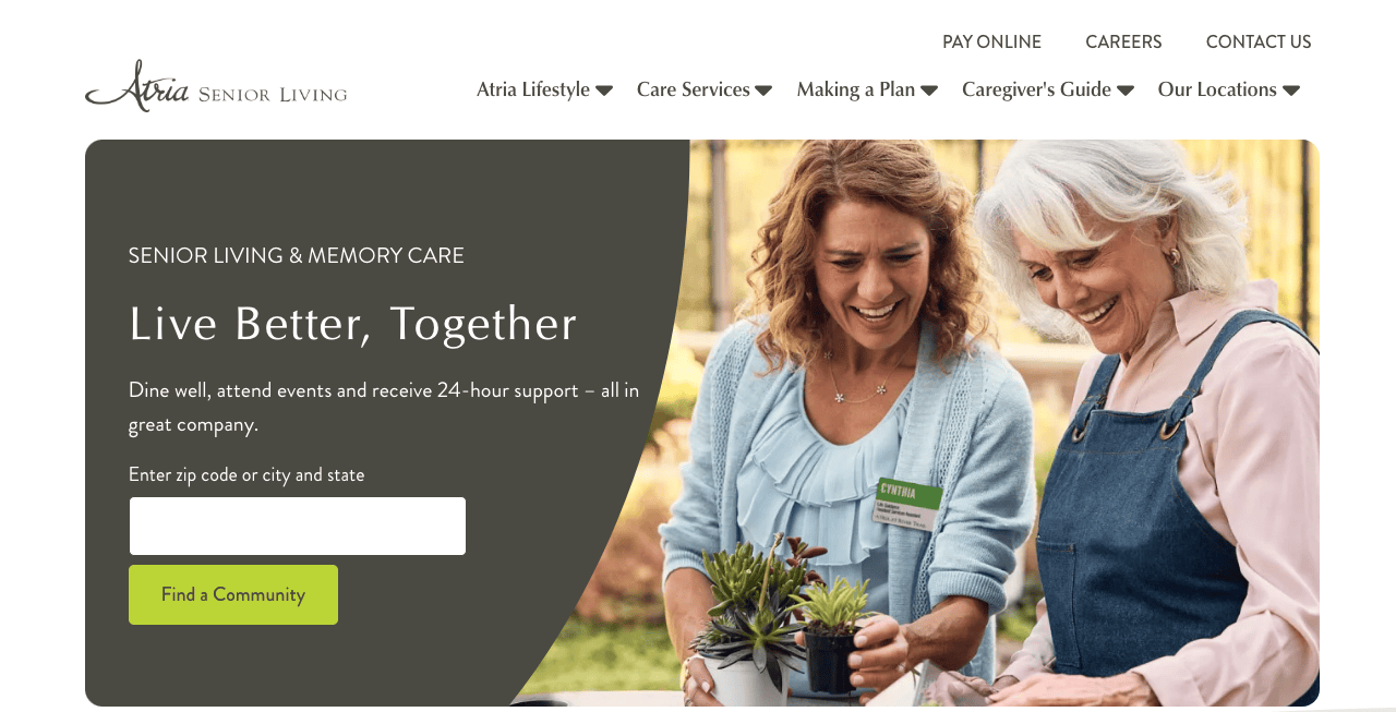 Two senior women smile and hold potted plants. Text on image promotes senior living and memory care services with a call to action to find a community.