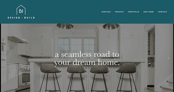 Website homepage showcasing a modern kitchen with white cabinets, a large island, and four bar stools. Text overlay reads "a seamless road to your dream home." Navigation menu is at the top.