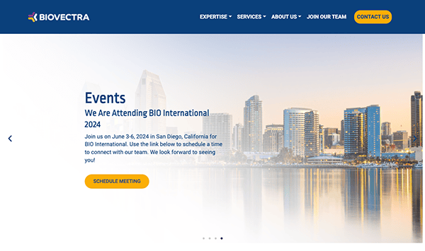 Web page for biovectra featuring a banner announcing their participation in the bio international event with a city skyline and calm water in the background.