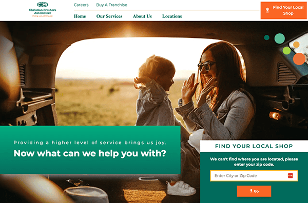 A website homepage for an automotive service company with a large promotional banner featuring a mother and daughter smiling and interacting inside a car.