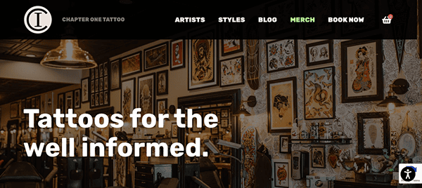 Website header for chapter one tattoo studio featuring a stylish, vintage-inspired interior lined with framed tattoo designs on the walls and a slogan stating "tattoos for the well informed.