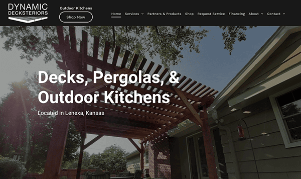 Image of a website for Dynamic Decksteriors, showcasing decks, pergolas, and outdoor kitchens. The page notes the business is located in Lenexa, Kansas. The site menu includes services, products, and contact info.