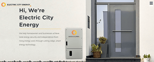 An Electric City Energy advertisement featuring a front entrance with plants and a door, showcasing their smart energy technology device mounted on a wall. The company offers energy security and cost-saving solutions.