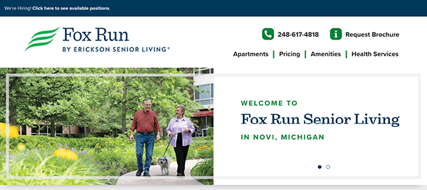 Homepage of Fox Run Senior Living showing two seniors walking a dog on a walkway surrounded by greenery, with contact information and links to Apartments, Pricing, Amenities, and Health Services.