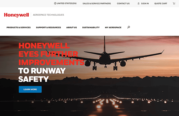 Website homepage of honeywell featuring a commercial airplane landing at sunset with illuminated runway lights and a navigation menu at the top.