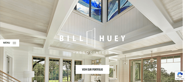Architectural firm's website featuring a modern interior with large windows and a skylight. The firm's name, Bill Huey + Associates, is displayed prominently, along with a button labeled "VIEW OUR PORTFOLIO.