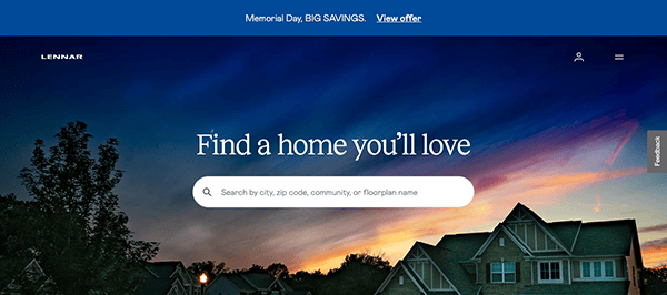 Website homepage with a search bar under the text "Find a home you'll love" against a sunset background, featuring houses in the foreground. A blue banner at the top mentions "Memorial Day, BIG SAVINGS. View offer.