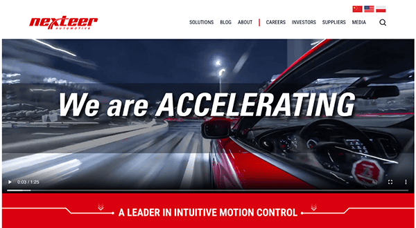 Screenshot of nexsteer website featuring a high-speed motion blur view from a car with the text "we are accelerating" displayed prominently.