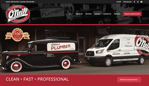 A black vintage vehicle and a white modern van, both branded with "O'Neill Plumbing Company," are parked outside a building. The header features contact details and navigation links.