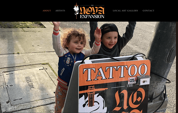 Two young children smiling and raising their arms near a street sign advertising a tattoo shop, with a website menu visible at the top.