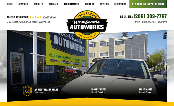 Front view of West Seattle Autoworks auto repair shop, with a white car parked outside and signage displaying contact information, services offered, and operational hours.