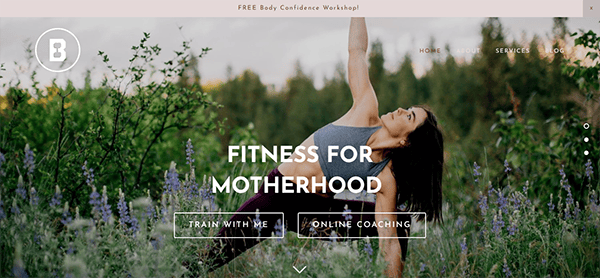 A woman performs a yoga pose on a grassy field. The website banner includes options for "Train with Me" and "Online Coaching," tailored for "Fitness for Motherhood." A workshop offer is displayed at the top.