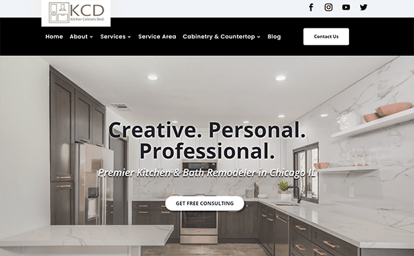 Screenshot of a website's homepage for KCD Kitchen Cabinets Divi, featuring a modern kitchen with white countertops and dark cabinets. Text reads: "Creative. Personal. Professional. Premier Kitchen & Bath Remodeler in Chicago, IL.