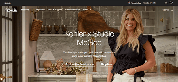 A woman stands in a kitchen next to text that reads, "Kohler x Studio McGee: Timeless style and expert craftsmanship take center stage in our inspiring collaboration.