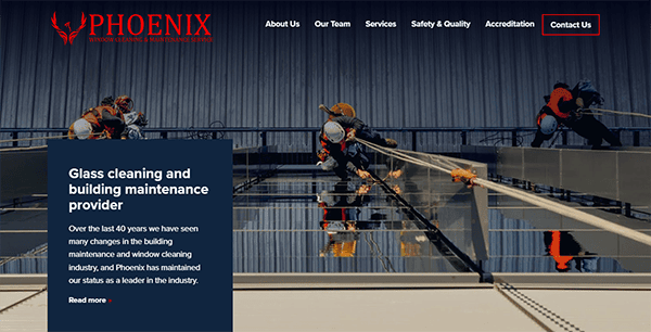 Glass cleaning workers suspended on the exterior of a building; website header reads "PHOENIX Window Cleaning & Maintenance Services" with menu options including "About Us" and "Contact Us.