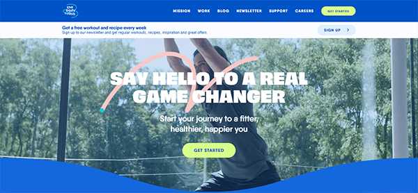 A person exercises outdoors under the text "Say Hello to a Real Game Changer. Start your journey to a fitter, healthier, happier you." The website's menu includes options like mission, work, and support.