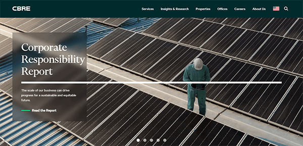 A person in green overalls stands beside solar panels on a roof. A text box on the left reads, "Corporate Responsibility Report," with a button that says "Read the Report.