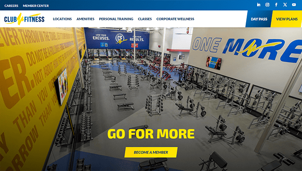 A modern gym interior featuring various workout equipment and mirrors. Motivational quotes are displayed on the walls. A prominent "Go for More" message is at the center with a "Become a Member" button below it.