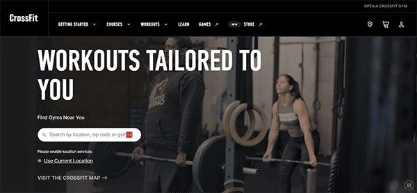 A woman lifts a barbell alongside a man at a gym. The text reads "Workouts tailored to you" with a search bar to find local CrossFit gyms.