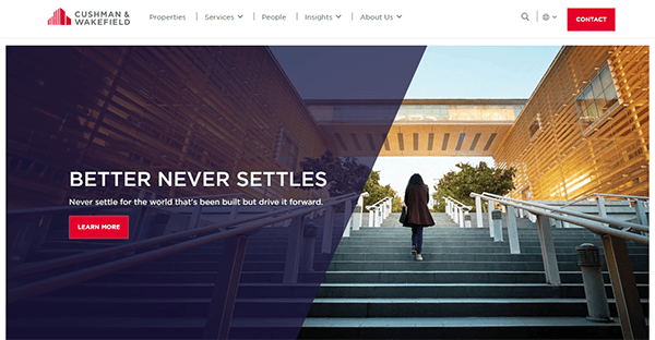 Website homepage of Cushman & Wakefield with a focus message "Better Never Settles" and a "Learn More" button. A person is walking up stairs in an outdoor modern architectural setting.