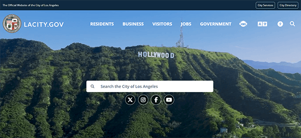 Screenshot of LACity.gov homepage featuring a search bar against a backdrop of the Hollywood Sign on a green hillside. Navigation links for Residents, Business, Visitors, Jobs, and Government are visible.