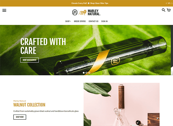 A webpage featuring Marley Natural products. The banner displays a glass pipe on a green leaf with the text "Crafted with Care." Below, there is an image of a wooden and glass accessory from the Walnut Collection.