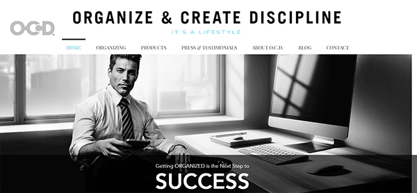 Black-and-white image of a professionally dressed man sitting at a desk with a computer, in an office setting. The website header reads, "Organize & Create Discipline. It's a lifestyle.