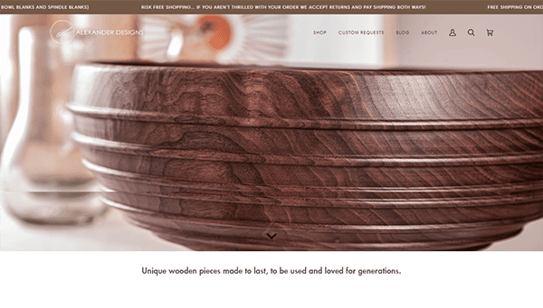 Close-up of a handcrafted wooden bowl with fine detailing. Website banner reads: “Alexander Designs” and highlights free shipping, return policy, and custom requests.