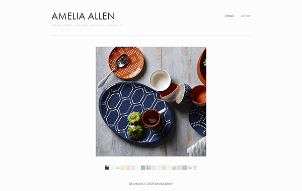 A website showcases a collection of patterned tableware, prominently featuring a blue hexagon-designed plate, white and orange bowls, and small cups, with the artist's name "Amelia Allen" above the image.