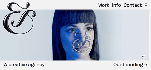 Woman with dark hair and bangs, with a metallic ampersand symbol in front of her face. Text reads: "A creative agency" and "Our branding" with navigation links at the top: Work, Info, Contact.