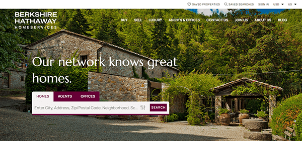 A rustic stone house surrounded by trees with the text "Our network knows great homes" and a search bar for homes, agents, and offices. The Berkshire Hathaway HomeServices logo is at the top left.