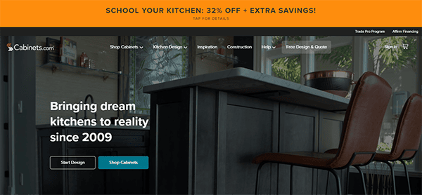 Homepage of a kitchen design website featuring an offer for 32% off. Large text reads, "Bringing dream kitchens to reality since 2009." The background shows a modern kitchen with a large island.