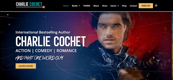 A website banner featuring Charlie Cochet, international bestselling author of action, comedy, and romance books. Text reads "And That One Weird Guy." A "Learn More" button is visible.