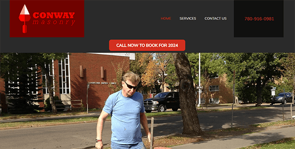 A man wearing sunglasses walks along a sidewalk with trees and a building in the background. The "Conway Masonry" website banner is displayed at the top of the image with a contact number and navigation links.