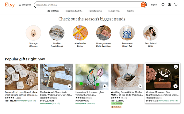 Screenshot of an Etsy webpage showcasing trending gifts and popular items such as a jewelry box, a wooden cutting board, a stained glass hummingbird, and other home decor.