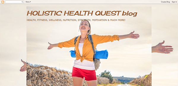 A woman stands on a trail with arms outstretched, wearing a yellow top, red shorts, and backpack. The text above reads "HOLISTIC HEALTH QUEST blog" with a subheading about health and wellness topics.