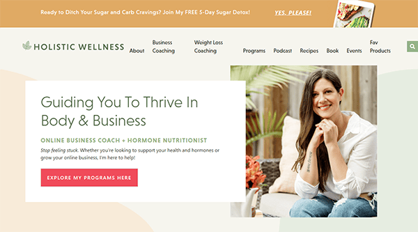 A wellness website homepage featuring a smiling woman, promoting business coaching and nutrition services with the tagline: "Guiding You To Thrive In Body & Business".