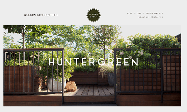 A website layout for HunterGreen, a garden design/build company. The homepage features a wooden deck with lush greenery, showcasing their expertise in hardscape design. A sleek logo sits at the top, accompanied by navigation links for projects, design services, and contact information—truly one of the best websites in its niche.