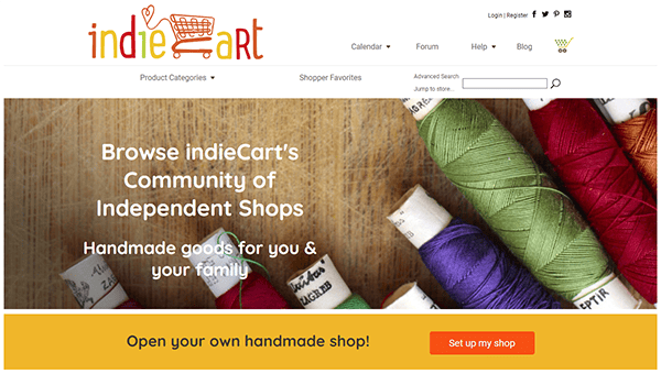 Homepage of indieCart website showing a banner promoting independent shops selling handmade goods, with colorful thread spools in the background and a button to set up a shop.