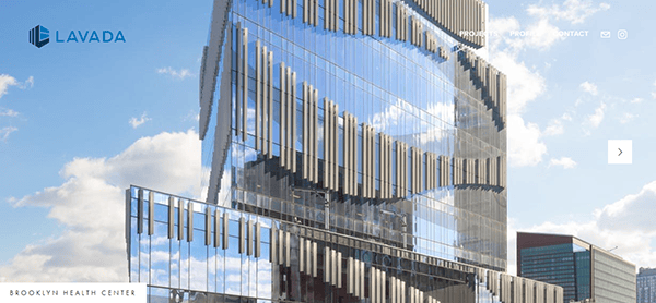 A modern, glass skyscraper with a unique, reflective design stands tall against a partly cloudy sky. The building features the logo and name "LaVada" and appears to house the Brooklyn Health Center.