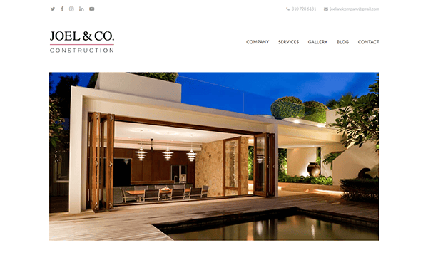 A modern, well-lit home with open sliding doors leading to a poolside deck is shown on the Joel & Co. Construction website. The header includes company contact details and navigation links.