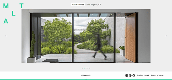 A modern office interior with large glass doors revealing a lush garden outside. A blurred figure walks past the doors. The text "MASH Studios - Los Angeles, CA" is visible at the top.