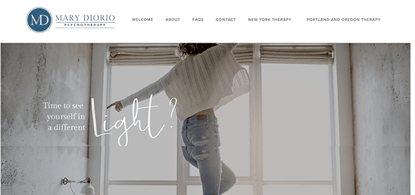 A person wearing a light-colored sweater and jeans raising an arm while standing near a window; text on the side reads, "Time to see yourself in a different Light?" The logo says "Mary Diorio Psychotherapy.