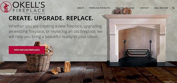 Homepage of Okell's Fireplace, featuring a fireplace with stacked firewood to the left. Main text reads "CREATE. UPGRADE. REPLACE." with a call-to-action button for gas fireplaces on the left side.