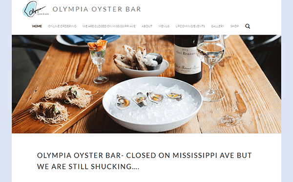 Image of a restaurant website featuring a dish of oysters on ice, a glass of white wine, and the text "Olympia Oyster Bar - Closed on Mississippi Ave but we are still shucking…".