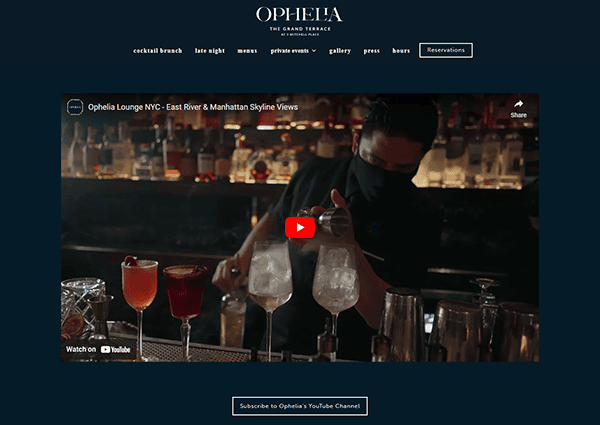 A masked bartender prepares cocktails at a dimly lit bar. The video is titled "Ophelia Lounge NYC - East River & Manhattan Skyline Views." The "Subscribe to Ophelia's YouTube Channel" button is visible below.