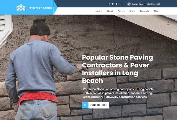 A man wearing a beanie and jacket works on a stone wall. The text reads "Popular Stone Paving Contractors & Paver Installers in Long Beach" with contact info for Patterson Stone.