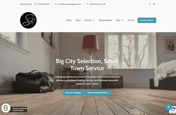 A website homepage for SB Flooring highlighting services in flooring, kitchen, and bathroom remodels. The page features a large image of a room with wooden flooring and buttons to contact and explore services.